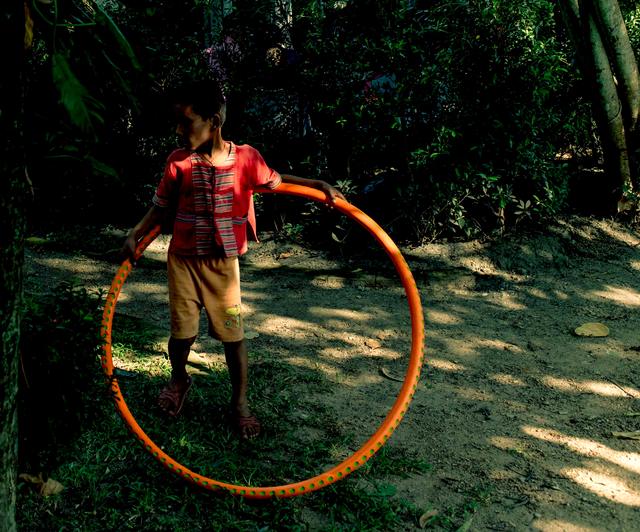 A child playing with a hula hoop